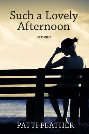 book cover: brown-grey background. A woman sits on a bench facing water. She wears a white t-shirt and capris. Her hair is in a bun. She is shown in profile, shadowed against a sunny day. She leans on her arm and appears to be contemplating something. With black typography at the top of the cover “Such a Lovely Afternoon” “stories”, and white text along the bottom of the cover “Patti Flather”